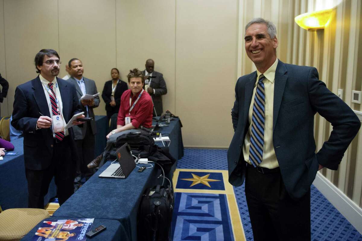 Oliver Luck speaks with members of the media at the NCAA Convention in Oxon, Md., Friday, Jan. 16, 2015. Former West Virginia athletic director and selection committee member Oliver Luck says the College Football Playoff should stay at four. Now with the NCAA, Luck says it should be hard to get into the playoff.