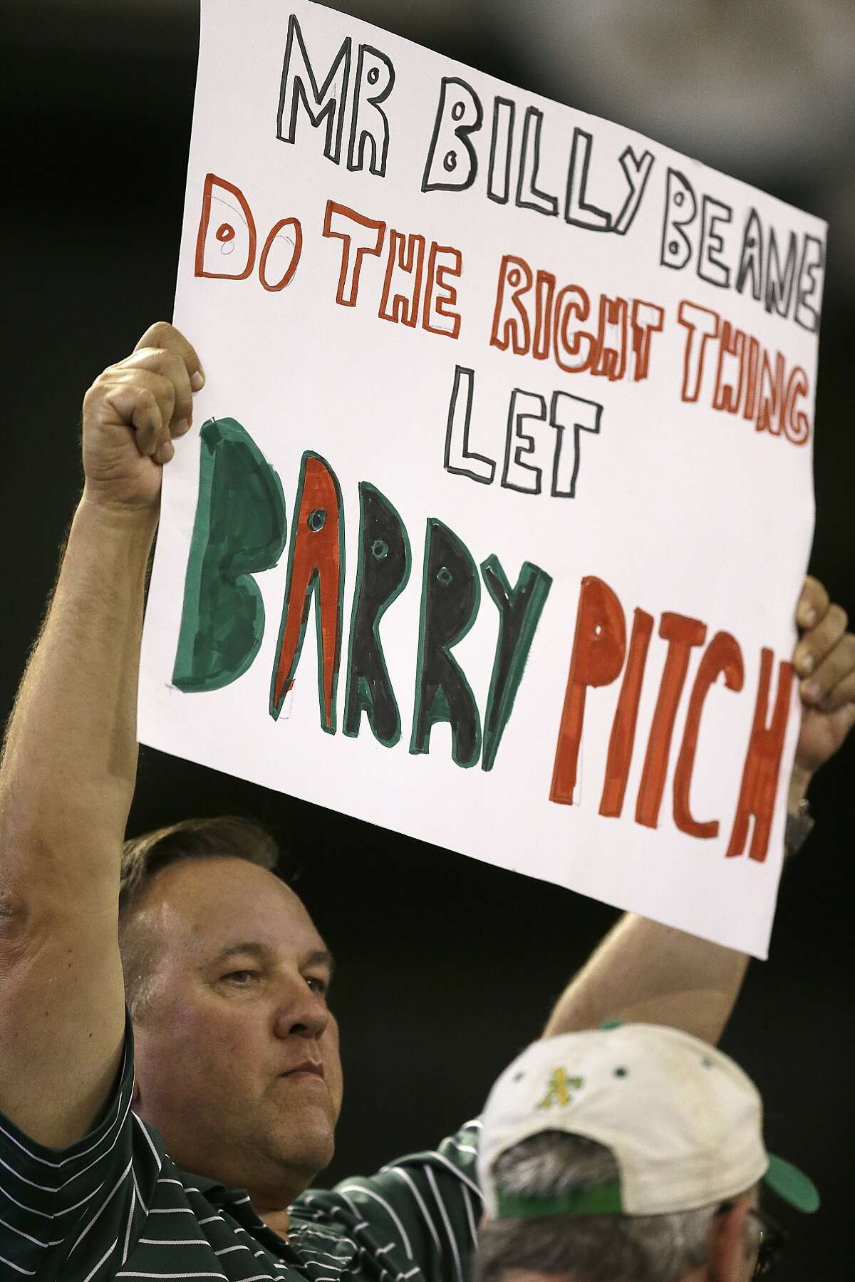 Oakland Athletics fan holds up a sign in reference to pitcher Barry Zito during a baseball game against the Houston Astros Wednesday, Sept. 9, 2015, in Oakland, Calif.