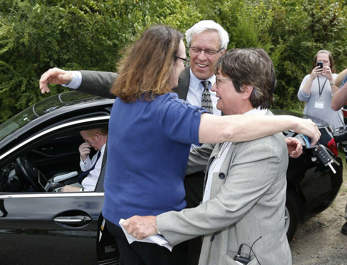 From left, Kathleen Lord, Don Knight, two of Richard Glossips's attorneys, and Sister Helen Prejean, a death penalty opponent, embrace outside the Oklahoma State Penitentiary in McAlester Okla., Wednesday, Sept. 16, 2015, after the scheduled execution for Glossip was stayed. Glossip was twice convicted of ordering the killing of Barry Van Treese, who owned the Oklahoma City motel where he worked. His co-worker, Justin Sneed, was convicted of fatally beating Van Treese and was a key prosecution witness in Glossip's trials.