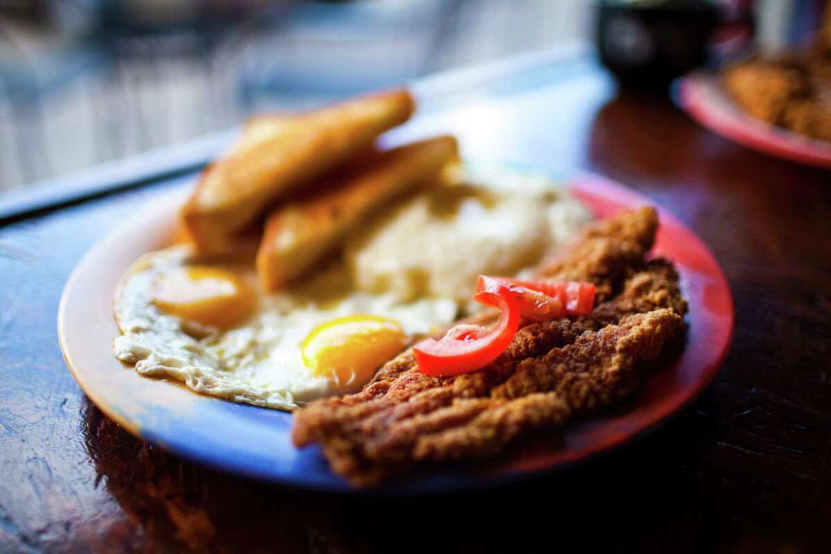 Katfish & Grits plate. Marcus Davis who along with his wife Mel, opened Breakfast Klub in Houston 10 years ago. They will be marking their 10th anniversary on Oct. 1. Photographed Sept. 20, 2011 in Houston. (Eric Kayne/For the Chronicle)
