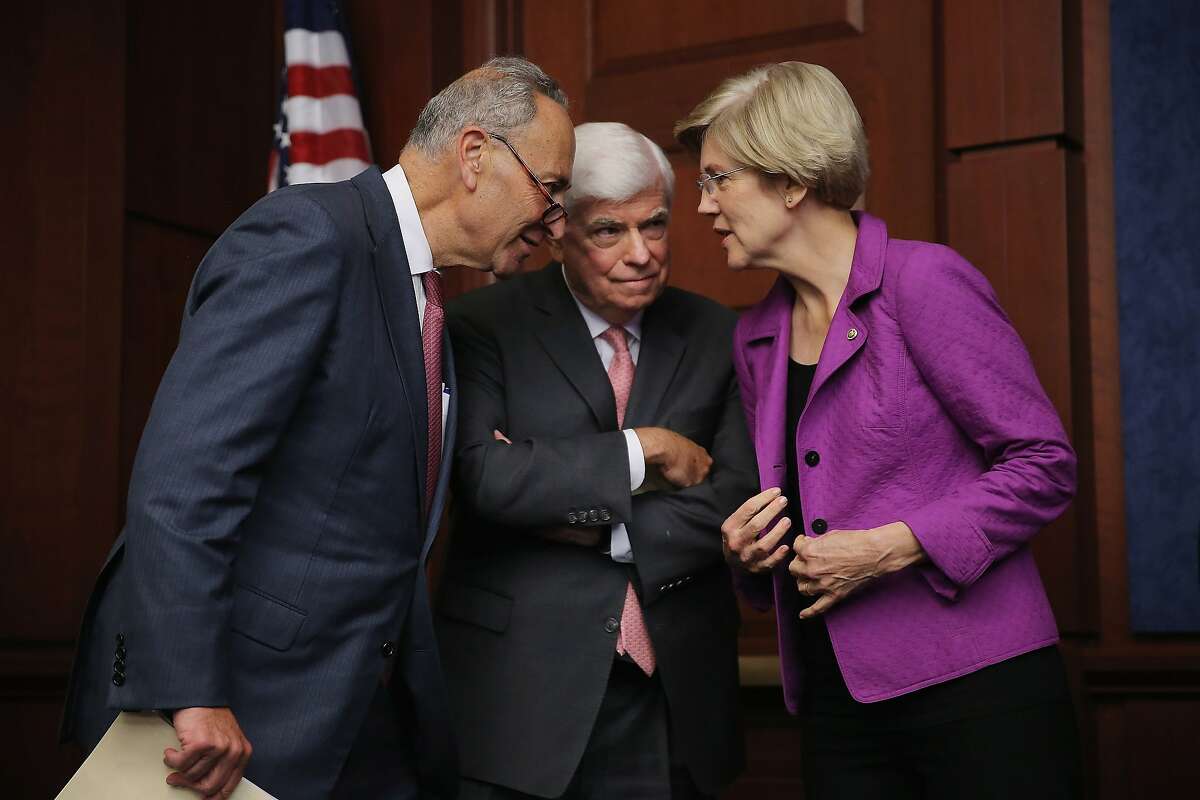 WASHINGTON, DC - JULY 21: Sen. Chuck Schumer (D-NY) (L) and Sen. Elizabeth Warren (D-MA) talk with former Sen. Chris Dodd (D-CT) during a news conference to discuss the fifth anniversary of the Dodd-Frank Wall Street Reform and Consumer Protection Act at the U.S. Capitol Visitors Center July 21, 2015 in Washington, DC. Dodd said the legislation has made great strides in reforming American financial institutions but more work lies ahead. (Photo by Chip Somodevilla/Getty Images) *** BESTPIX ***