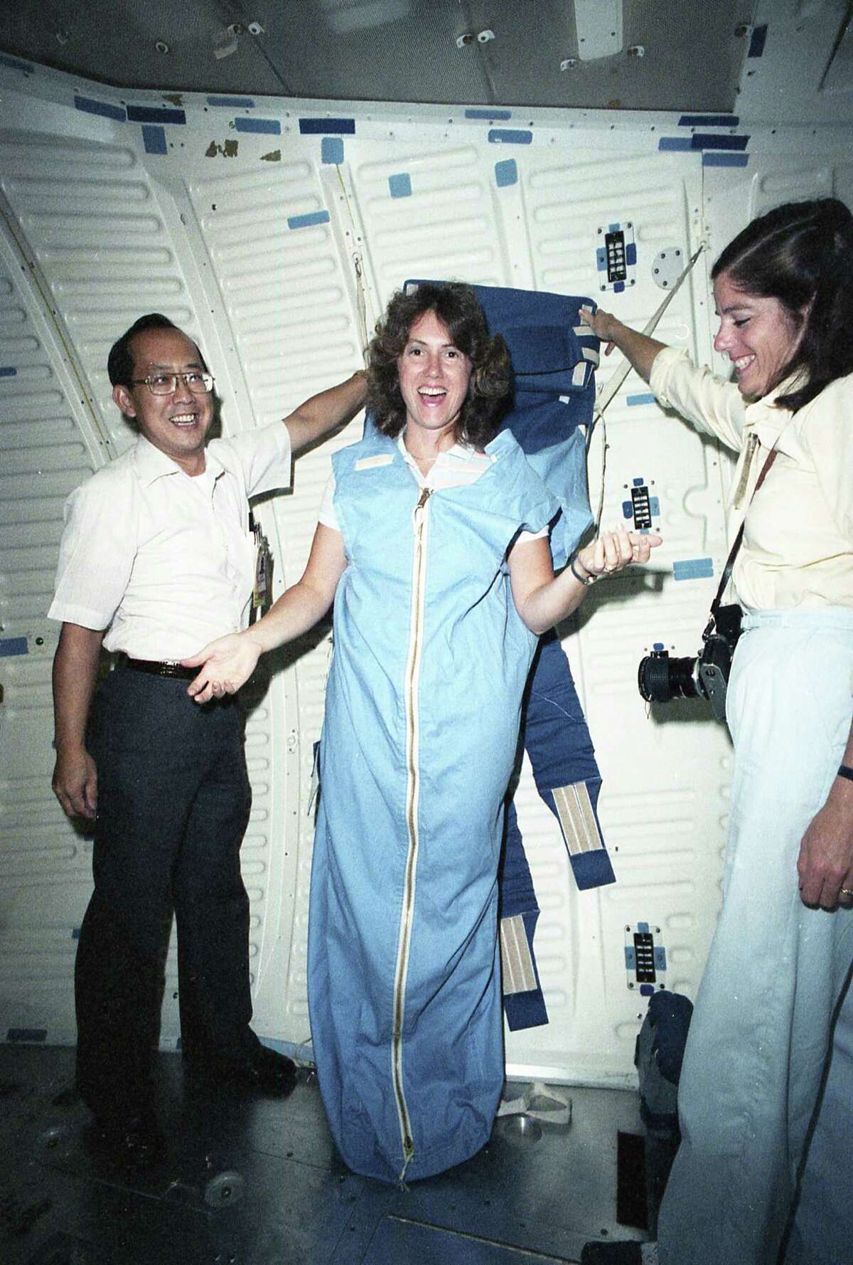 Teacher Christa McAuliffe gets a tour of the space shuttle mockups at the public affairs offices at the Johnson Space Center, Sept. 12, 1985. With her is teacher Barbara Morgan, right.