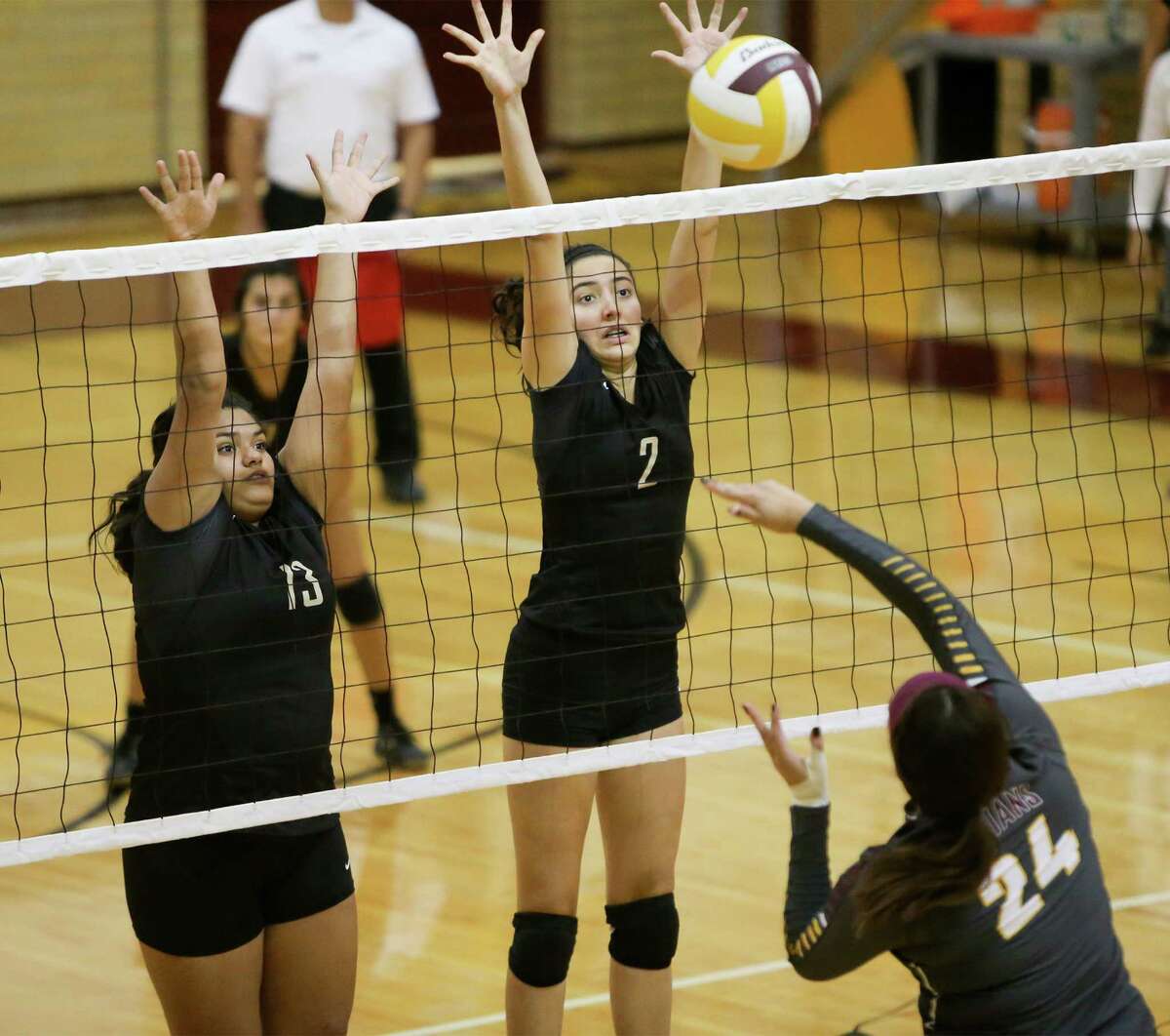 Edison's Nayelli Hernandez (from left) and Liann Mayen attempt to block a shot by Harlandale's Tanya Ramos during their match at Harlandale on Tuesday, Sept. 8, 2015. Edison won the match 3-2. MARVIN PFEIFFER/ mpfeiffer@express-news.net
