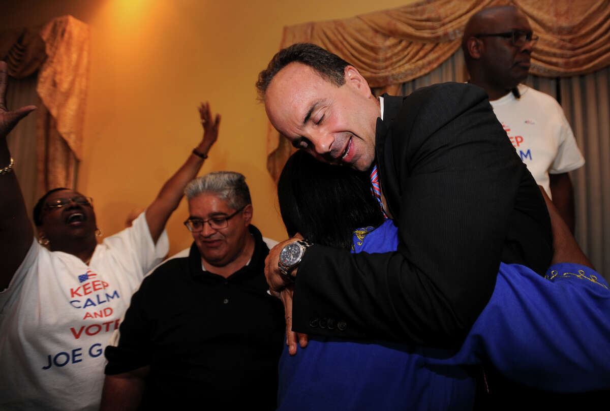 Former Bridgeport Mayor Joseph Ganim hugs Reverend Mary Lee at Testo's Restaurant in Bridgeport, Conn. after winning the Democratic mayoral primary on Wednesday, September 16, 2015.