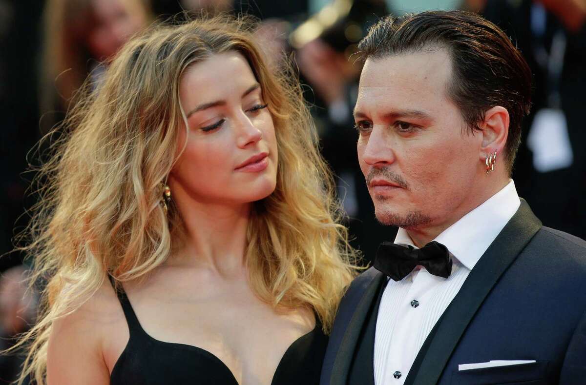 Amber Heard, left, and Johnny Depp are shown at the premiere of the film "Black Mass" during the Venice Film Festival in Venice, Italy, in 2015. 