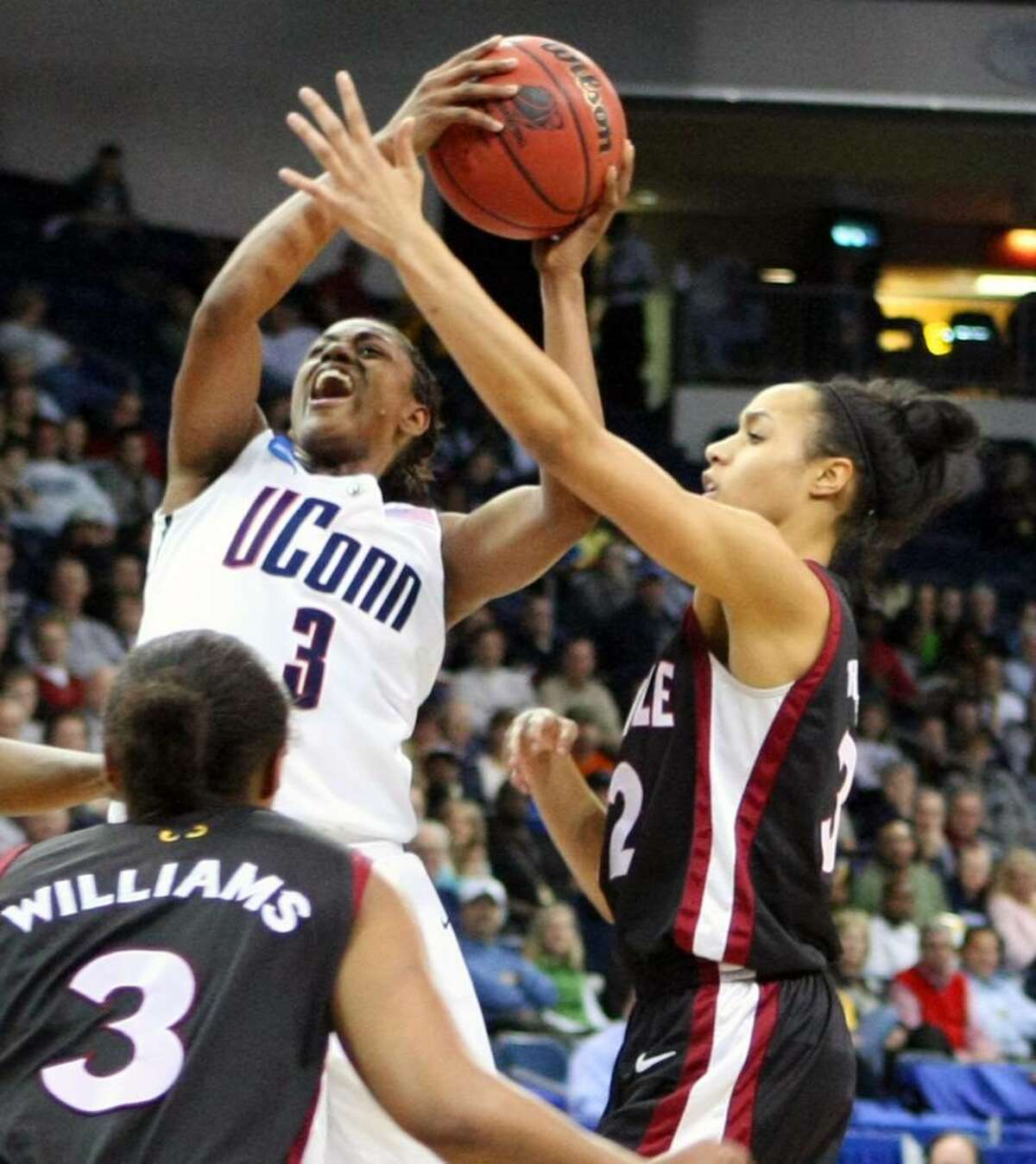 Connecticut's Tiffany Hayes, left, shoots over Temple's Natasha Thames, right and B.J. Williams, left, during the first half of their NCAA college basketball game, Tuesday, March 23, 2010, at the Constant Center in Norfolk, Va. (AP Photo/Jason Hirschfeld)
