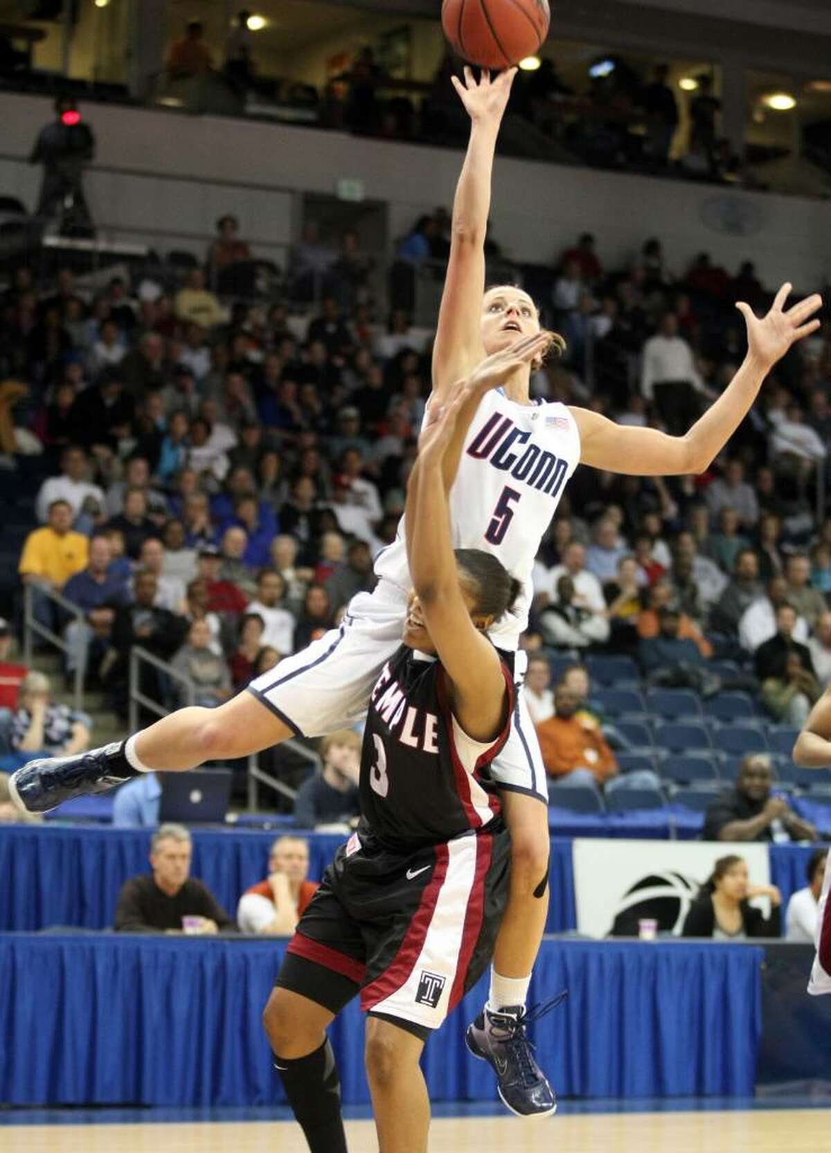 Connecticut's Caroline Doty is fouled by Temple's B.J. Williams in the first half of an NCAA college basketball tournament game, Tuesday, March 23, 2010, in Norfolk, Va. (AP Photo/Jason Hirschfeld)