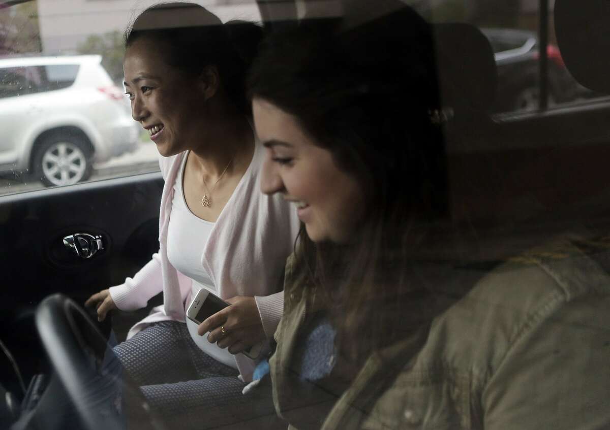 Donna Scarola, driver, picks up Betty Cao in Oakland, Ca. before driving to their jobs in Pleasanton, Ca. on Wednesday, September 16, 2015. This is the second time the pair has carpooled together to work. They met via a new app called Scoop.