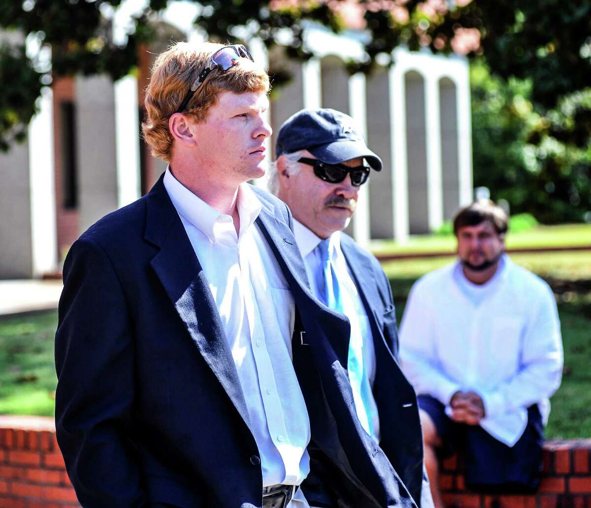Former University of Mississippi student Graeme Phillip Harris, left, with his attorney David Hill, leaves federal court after being sentenced, Thursday, Sept. 17, 2015 in Oxford, Miss. Harris, a former University of Mississippi student who admitted helping place a noose on a statue of a civil rights activist is going to prison. U.S. District Judge Michael P. Mills sentenced Graeme Phillip Harris on Thursday to six months in prison beginning Jan. 4, followed by 12 months' supervised release. (Bruce Newman/The Oxford Eagle via AP) NO SALES; MANDATORY CREDIT