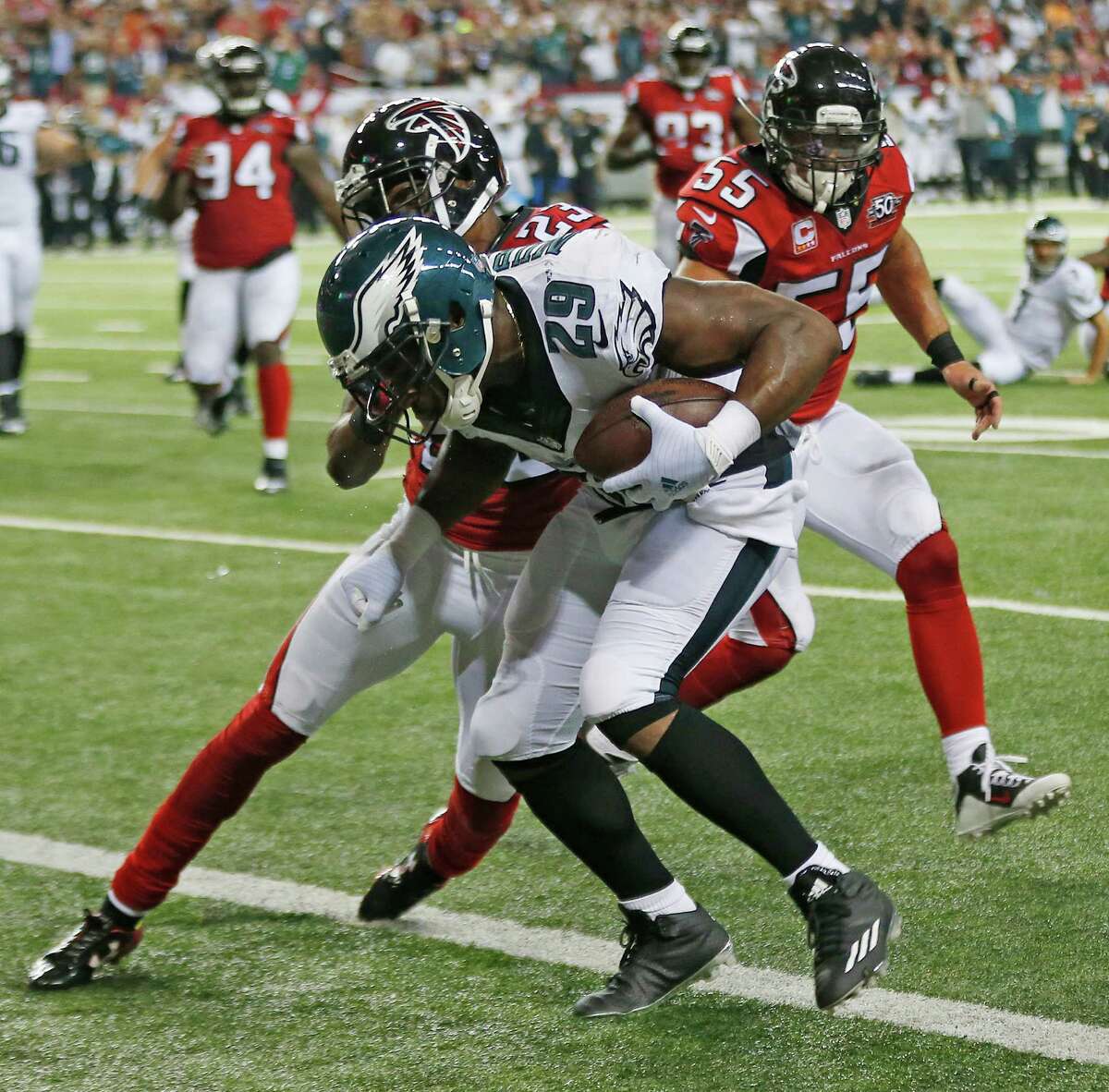 Atlanta Falcons cornerback Robert Alford (23) hits Philadelphia Eagles running back DeMarco Murray (29) after murray scores a touchdown during the second half of an NFL football game, Monday, Sept. 14, 2015, in Atlanta. (AP Photo/John Bazemore)