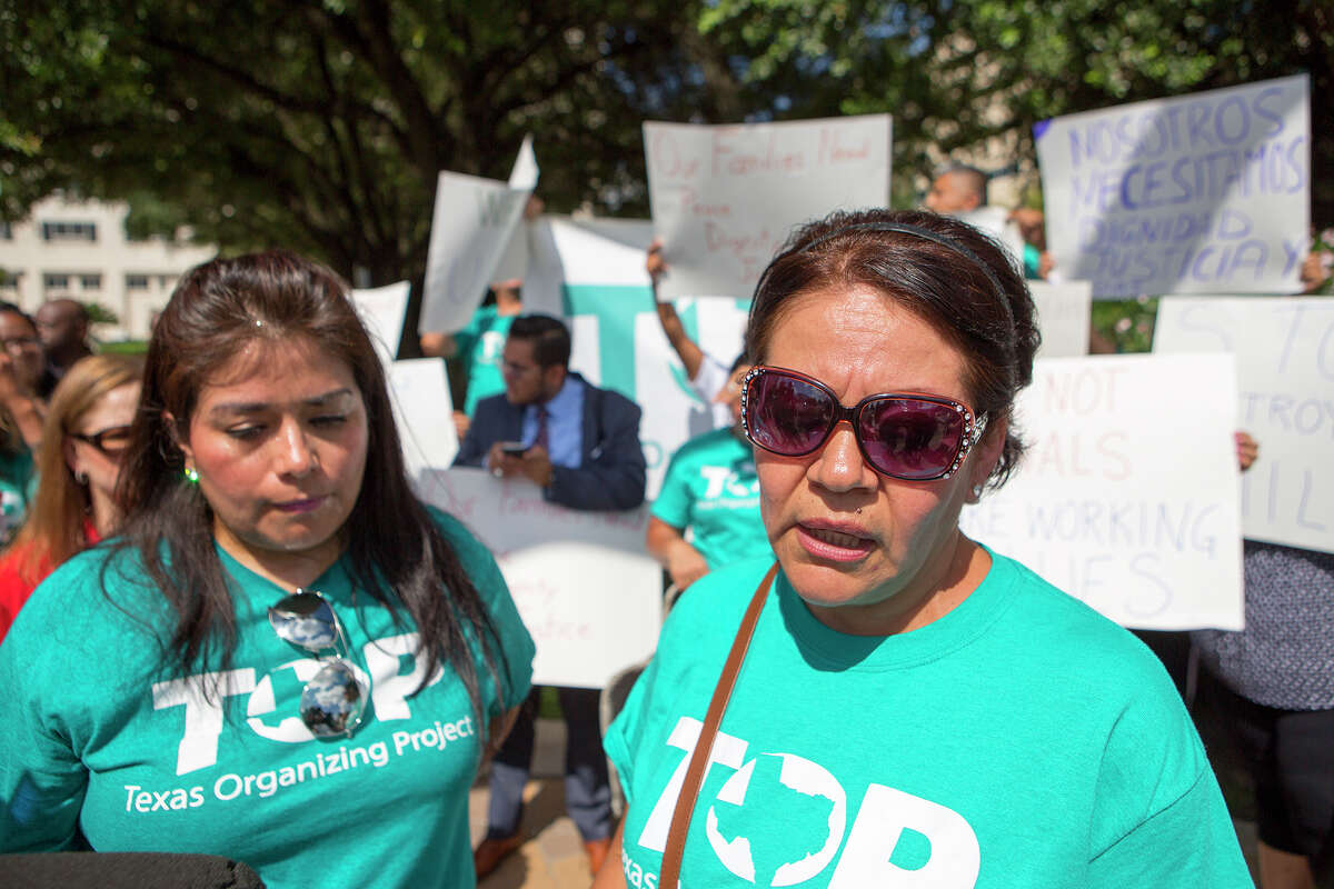 Mary Moreno, communications director for the Texas Organizing Project, left, and TOP community leader, Maria De Leon, right, speak during a protest at Memorial Hermann Health System's headquarters, Thursday, Sept. 17, 2015, in Houston. The protest was held after the arrest of Blanca Borrego, an undocumented mother who was seeking medical treatment.