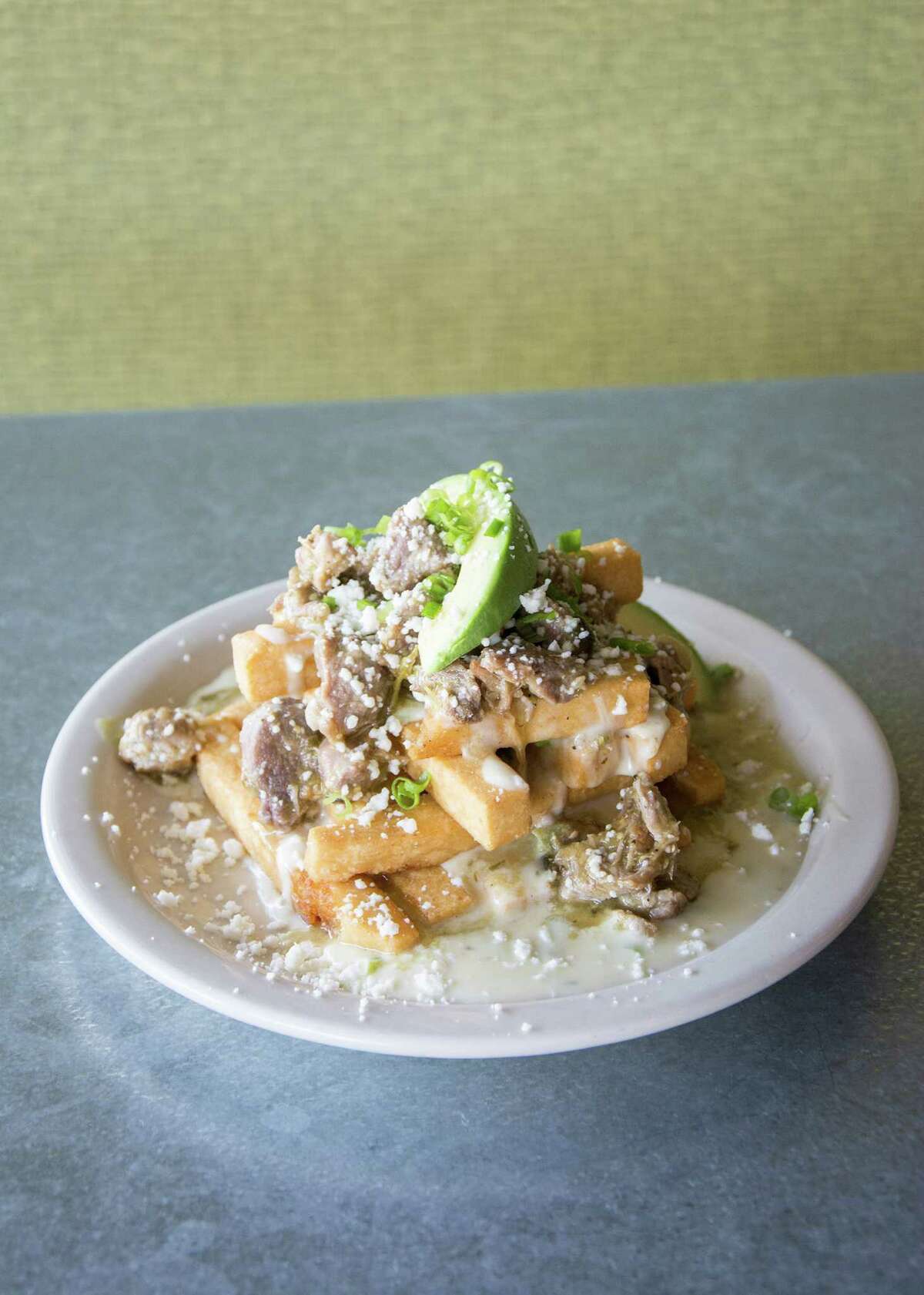 The masa fries at Flair include green chile pork and queso blanco.