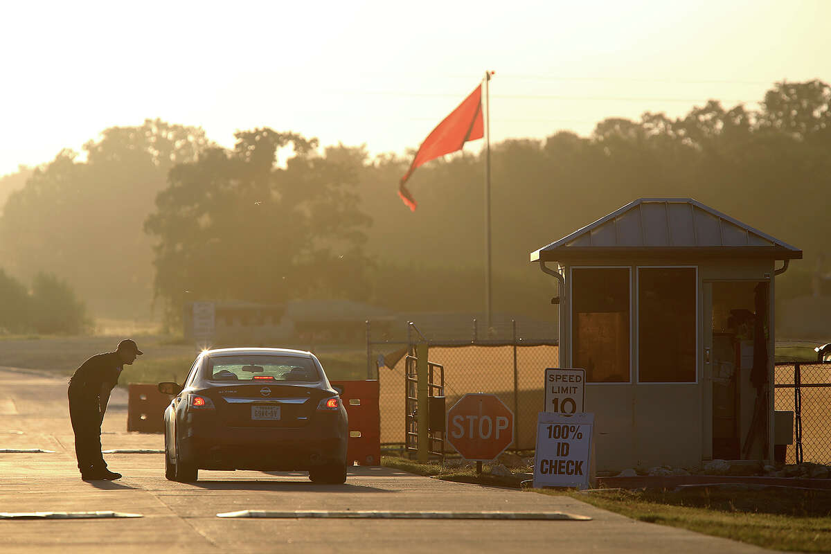 FILE: A security guard checks incoming traffic at Camp Swift, Texas, north of Bastrop, Texas, Wednesday, July 15, 2015. It was the first day of the U.S. Army Special Operations exercise, "Jade Helm 15," at the camp.