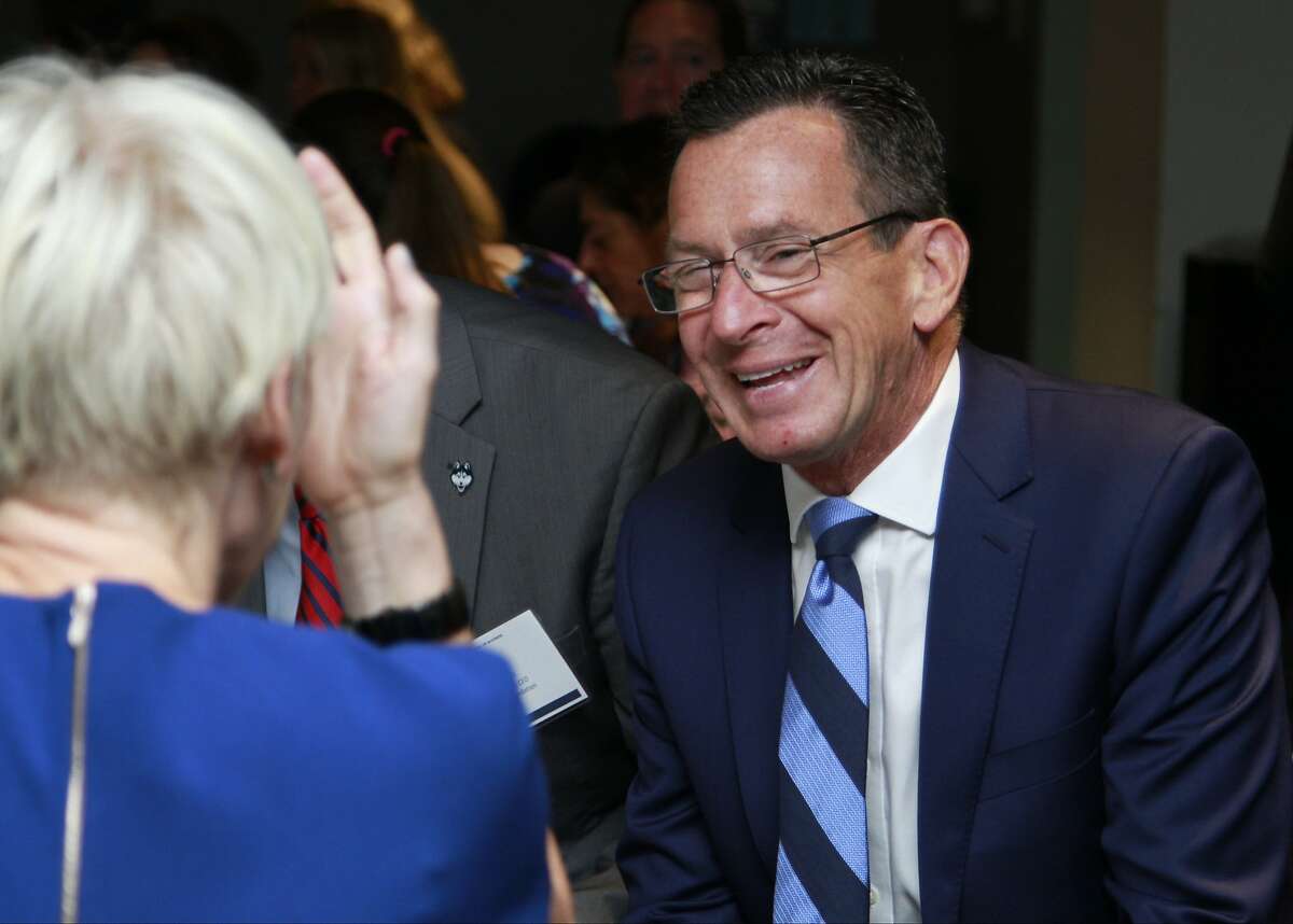 Joanna Coles, Editor-in-Chief of Cosmopolitan and Editorial Director of Hearst Magazines, center, chats with Connecticut Gov. Dannel Malloy during a Women Entrepreneurs Empowerment Forum where Coles sat down with University of Connecticut President Susan Herbst for a Q&A in Stamford on Friday Sept. 18, 2015.