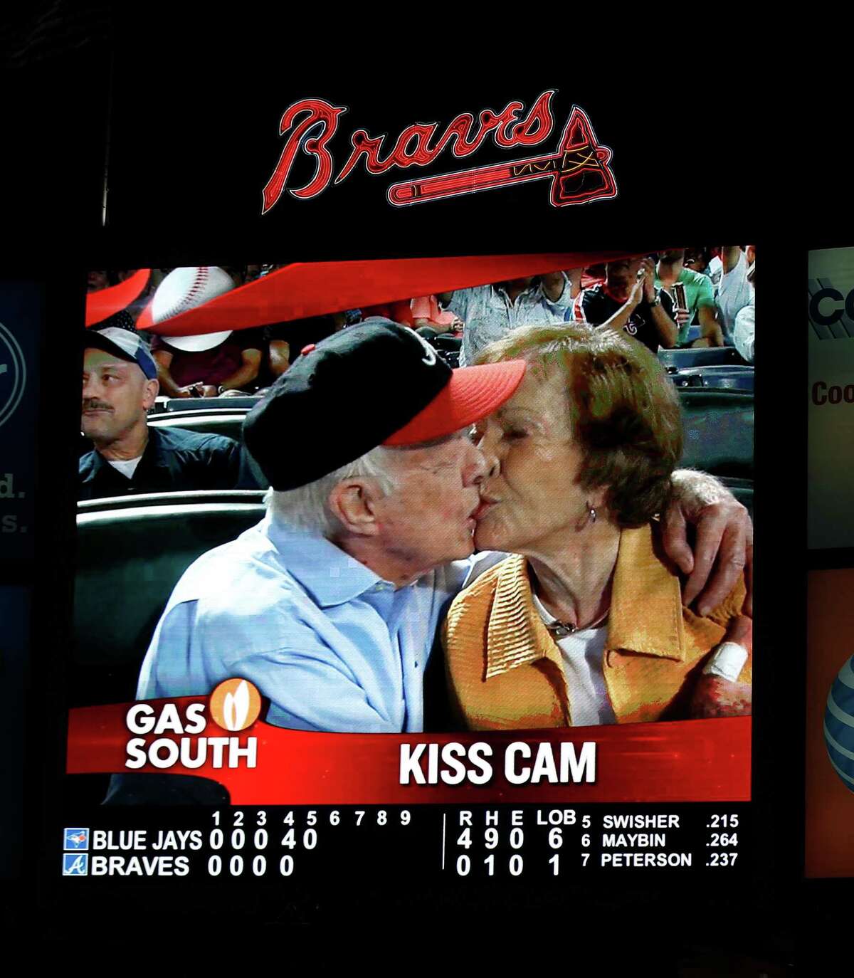Former President Jimmy Carter and his wife,Rosalynn, paid heed to the "Kiss Cam." during a baseball game between the Atlanta Braves and the Toronto Blue Jays on Thursday, Sept. 17, 2015, in Atlanta. Carter recently announced he has cancer. (AP Photo/John Bazemore)