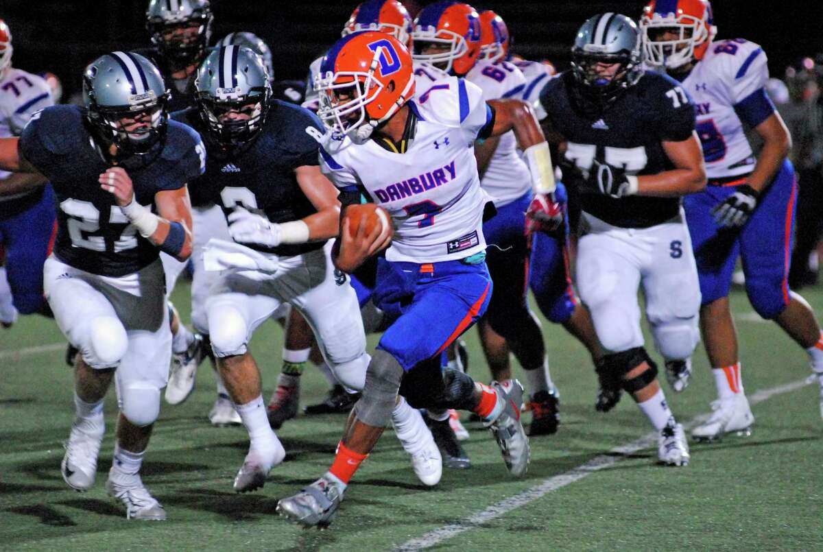 Danbury's Marvin Payton, right carries during Staples' 21-14 win over Danbury on Friday, Sept. 18, 2015 in Westport, Connecticut.