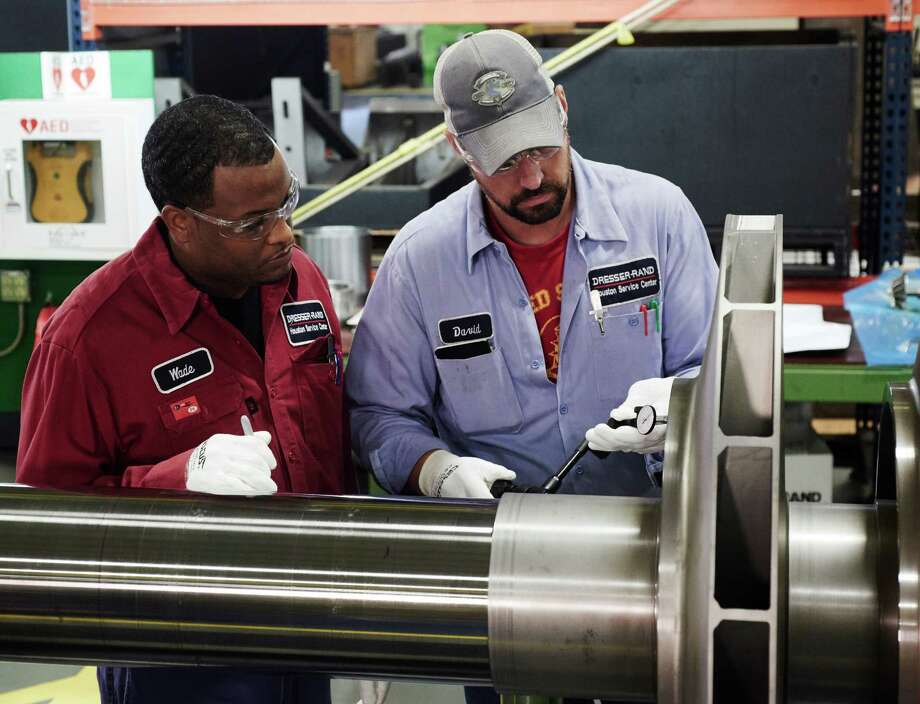 After Recent Ing Spree Siemens Not Planning Further Dresser Rand Machinists Inspect A Compressor Rotor At The Company S Lumpkin Road Service Center In