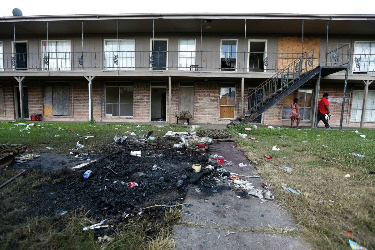 The remains of a mattress fire and trash in the courtyard of the Crestmont Apartments 5602 Selinsky Road Friday, Sept. 18, 2015, in Houston. Mayor Parker held a news conference Thursday to announce the city is intervening to help the residents of the rundown Crestmont Apartments on Selinsky at Martin Luther King Drive. The tenants have been without power because the landlord has refused to pay the bill. This has created a public safety emergency for the residents. The City is arranging to get the power turned back on and has asked the Red Cross to help with food and water for the time being. The City is working to find new housing for the tenants.