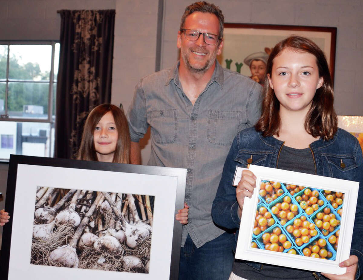 Young Shoots photo contest first-place winners, Esme Stiel, left, in the 8 to 10-year-old category and Lili Dowell, first-place in in the 11 to 14-year-old category, with Bill Taibe, owner of The Whelk restaurant, where the winners will co-lead a photo shoot as one of their prizes.