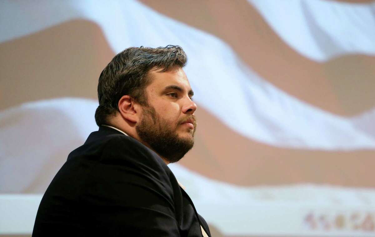 State Rep. Jonathan Stickland (R-Bedford) moderates a talk given by Wallace Hall, president of Wetland Partners, at the North East Tarrant Tea Party meeting at the North Richland Hills Centre Monday, Aug. 10, 2015, in North Richland Hills, Texas. He is pushing to unseat Rep. Sarah Davis, a Republican from West University Place he contends is too liberal.