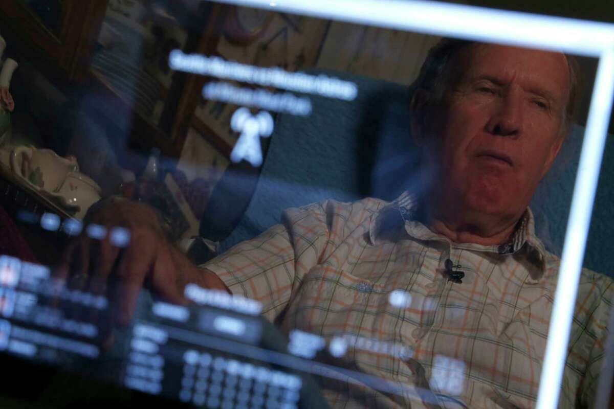 Danny Flowers is reflected in the screen of a computer, the window through which Flowers, who is nearly blind, sees the world of Astros baseball.﻿