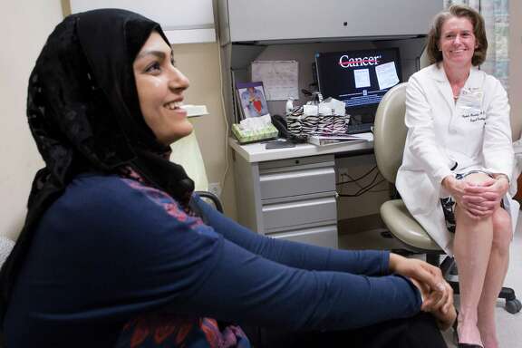 Sadaf Zaidi, left, a recently recovered breast cancer patient accepts an invitation by Dr. Elizabeth Mittendorf of M.D. Anderson Cancer Center to participate on the clinical trial of a vaccine that shows promise for preventing the recurrence of breast cancer.