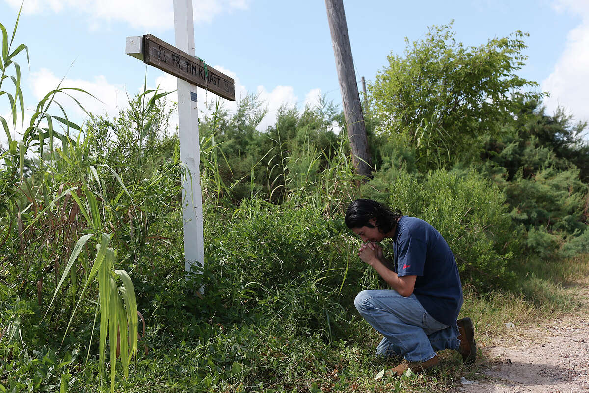 Iraq War veteran Sabastian Vasquez, 32, pays his respect at a memorial for family friend and parish priest, Tim Kinast, by the Austwell Pier near his hometown of Tivoli, Texas, Wednesday, August 6, 2015. Vasquez made three tours in Iraq and was diagnosed with Post-Traumatic Stress Disorder. The U.S. Marine left the service in 2005 and ten years later he is still dealing with the PTSD. Kinast was a close family friend and died while kayaking in 2003.