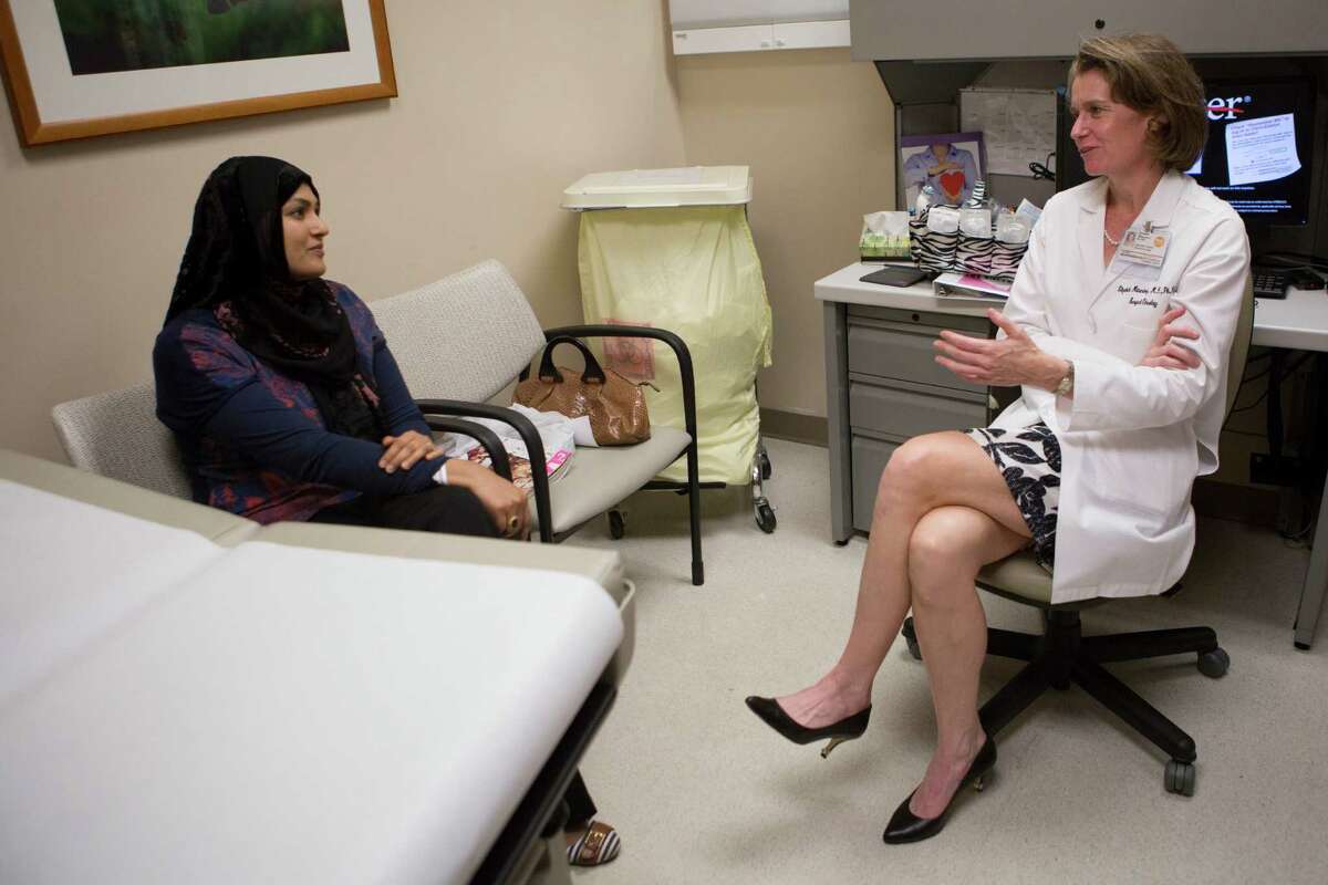 Zaidi Sadaf, left, a recently recovered breast cancer patient accepts an invitation by Elizabeth A. Mittendorf, an associate professor in the Department of Surgical Oncology at the University of Texas MD Anderson Cancer Center to participate on the clinical trial of a vaccine that that shows promise for preventing recurrence of breast cancer. Tuesday, Aug. 25, 2015, in Houston. ( Marie D. De Jesus / Houston Chronicle )