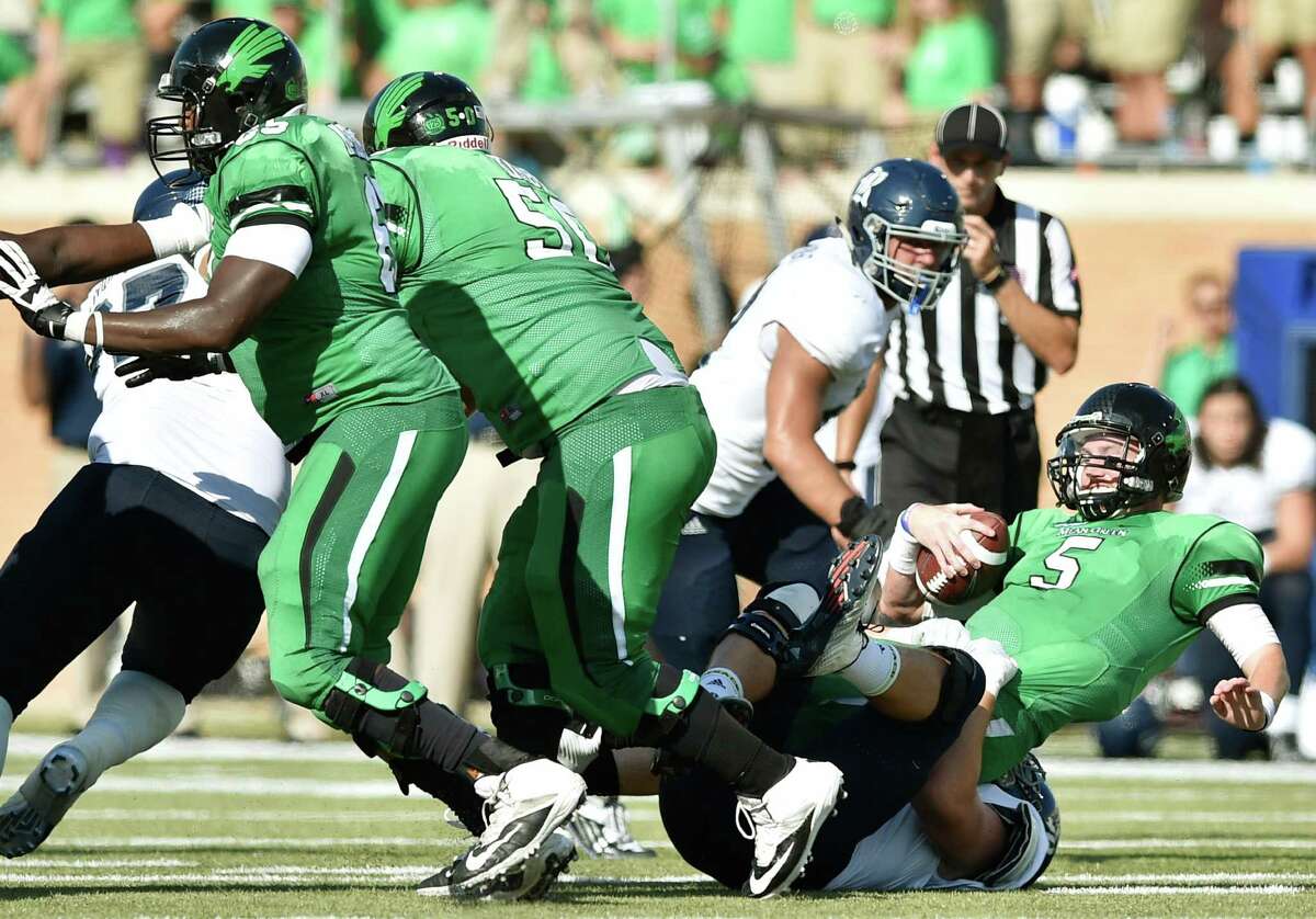 North Texas quarterback Andrew McNulty (5) had his hands full against Rice's defense, taking a tumble on this sack by Rice defensive end Parker Hanusa.