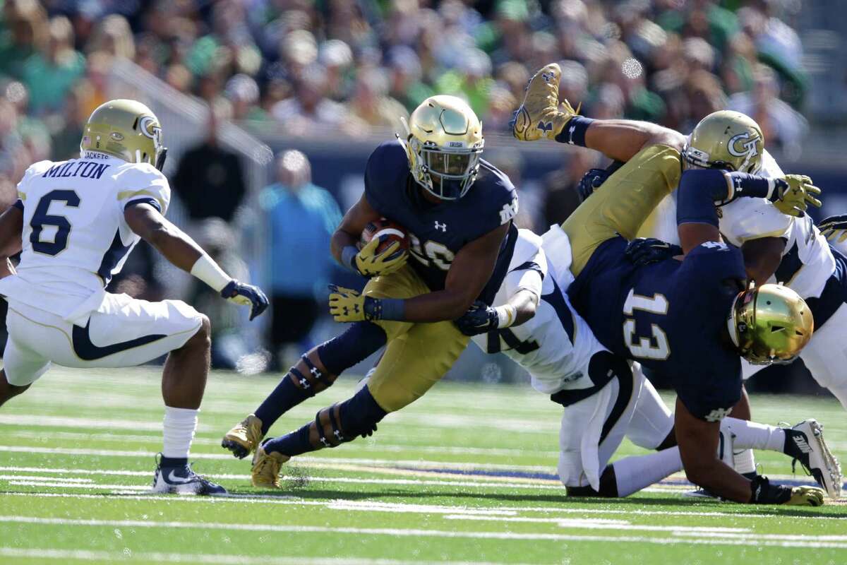 Notre Dame running back C.J. Prosise (20) cuts in front of Georgia Tech defensive back Chris Milton (6) during the first half of an NCAA college football game in South Bend, Ind., Saturday, Sept. 19, 2015. (AP Photo/Michael Conroy)