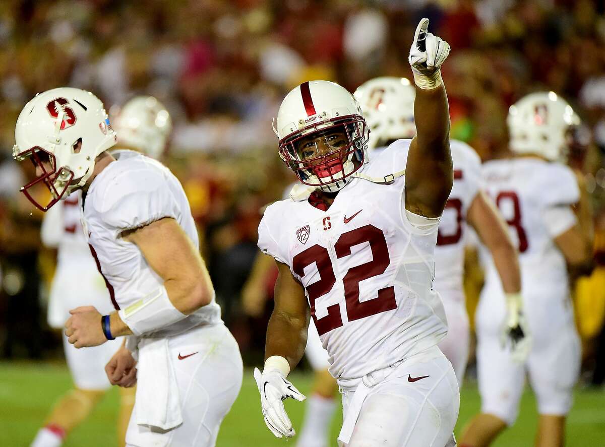 LOS ANGELES, CA - SEPTEMBER 19: Remound Wright #22 of the Stanford Cardinal celebrates his touchdown to take a 38-28 lead over the USC Trojans during the fourth quarter at Los Angeles Coliseum on September 19, 2015 in Los Angeles, California. (Photo by Harry How/Getty Images)