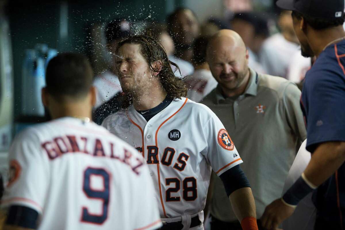 Astros outfielder Colby Rasmus, center, cools off after his solo home run in the second inning, the first of his two homers on the day in the win over the A's.