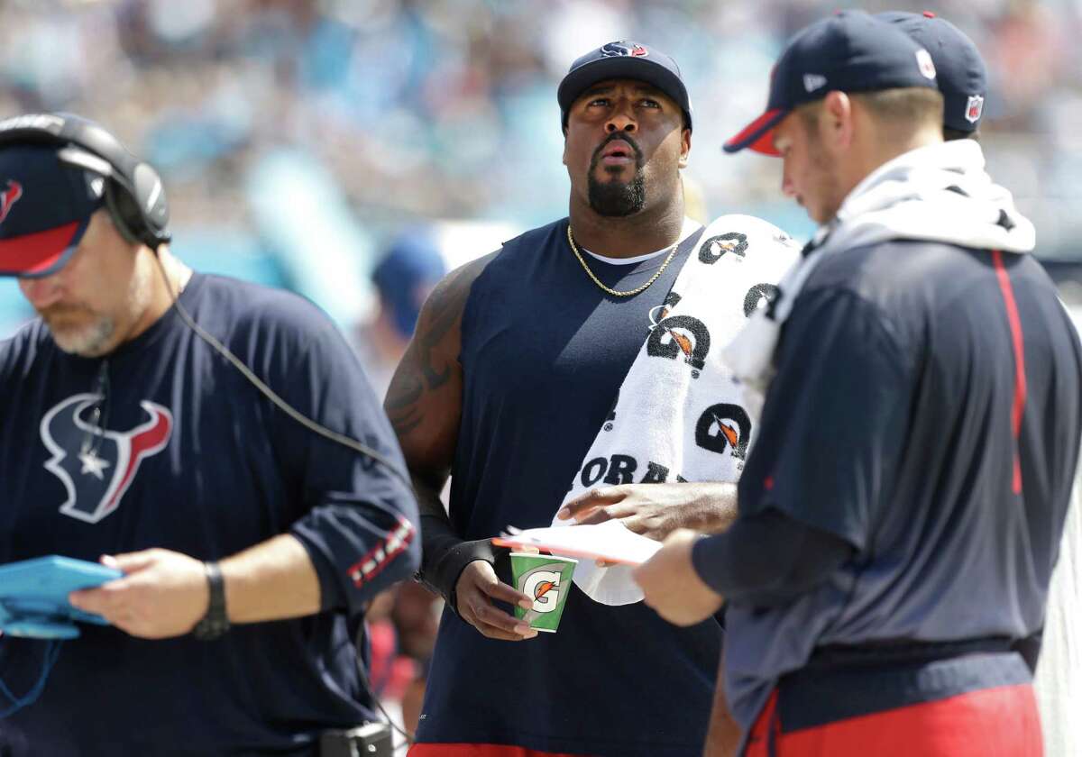 Texans tackle Duane Brown, center, stands on the sidelines Sunday during the first quarter. With Brown out, the Texans had to mix and match the offensive line.