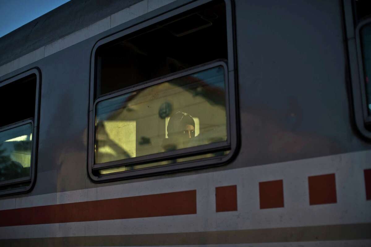 A woman looks through the window of a train she boarded with other migrants and refugees, close to Croatia's border with Serbia, in Tovarnik, Croatia, Monday, Sept. 21, 2015. Croatia has been under extreme pressure since thousands of asylum seekers got stuck there after Hungary shut its border last week. (AP Photo/Marko Drobnjakovic)
