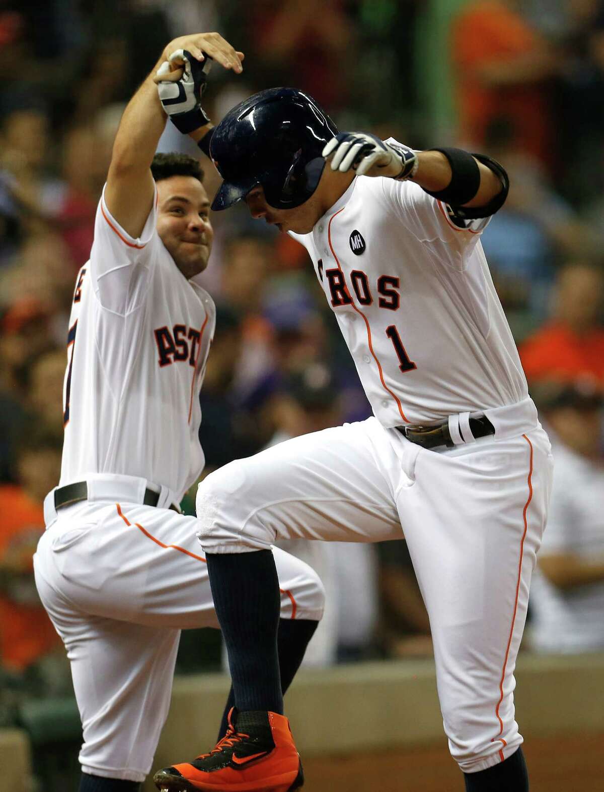 Astros shortstop Carlos Correa (1), a day shy of his 21st birthday, celebrates his 19th homer of the season, a two-run shot in the third inning, with Jose Altuve.