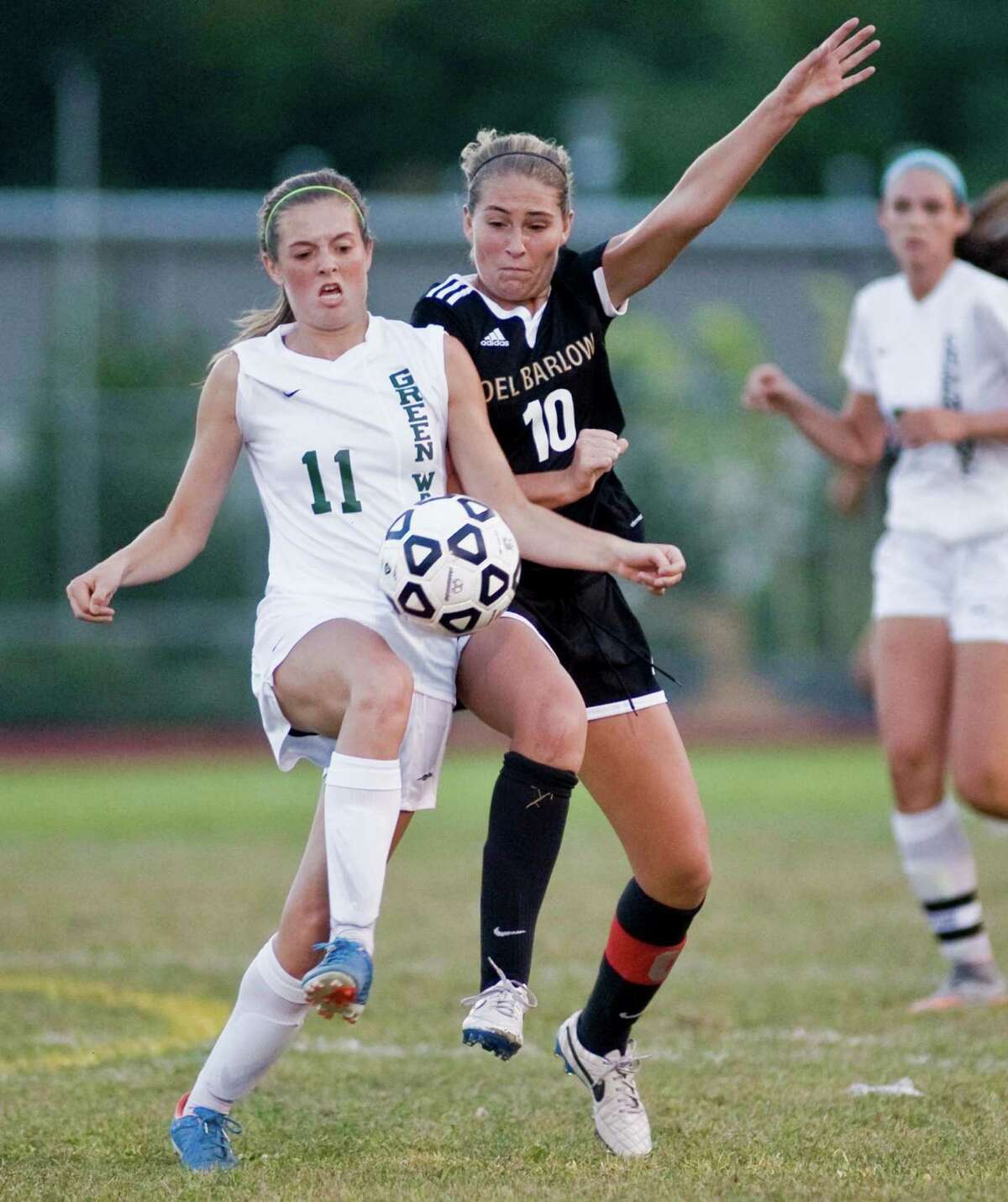 New Milford High School's Hannah Tower and Joel Barlow High School's Amelia Blackwell try and take control of the ball during a game at New Milford High School. Monday, Sept. 21, 2015