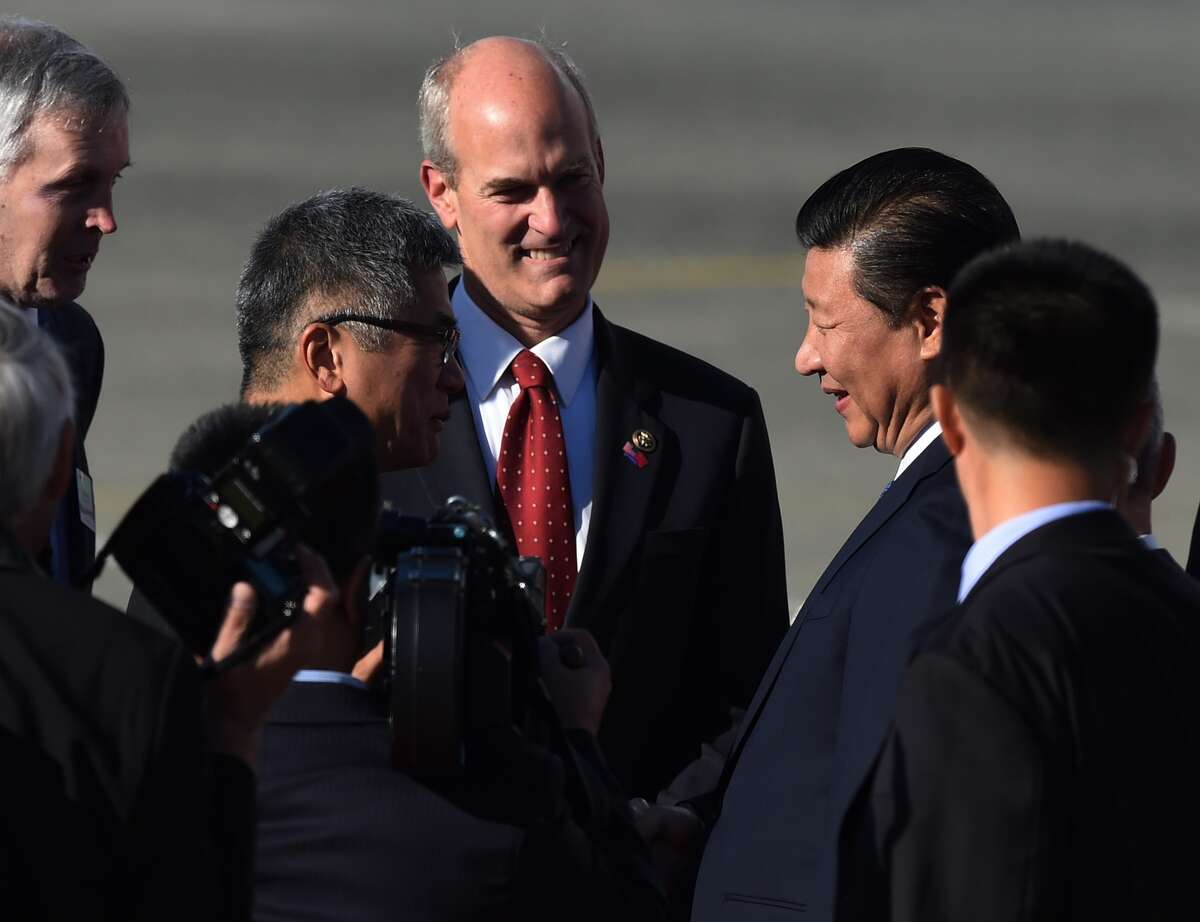 Chinese President Xi Jinping (R) talks with Gary Locke, a former US ambassador to China (L) after arriving for a one week visit to the United States, at Boeing's Paine Field in Seattle, Washington on September 22, 2015. Plans for a Boeing factory in China have been submitted to the government in Beijing, state-run media reported ahead of President Xi Jinping's US visit, where he will tour one of its plants. 