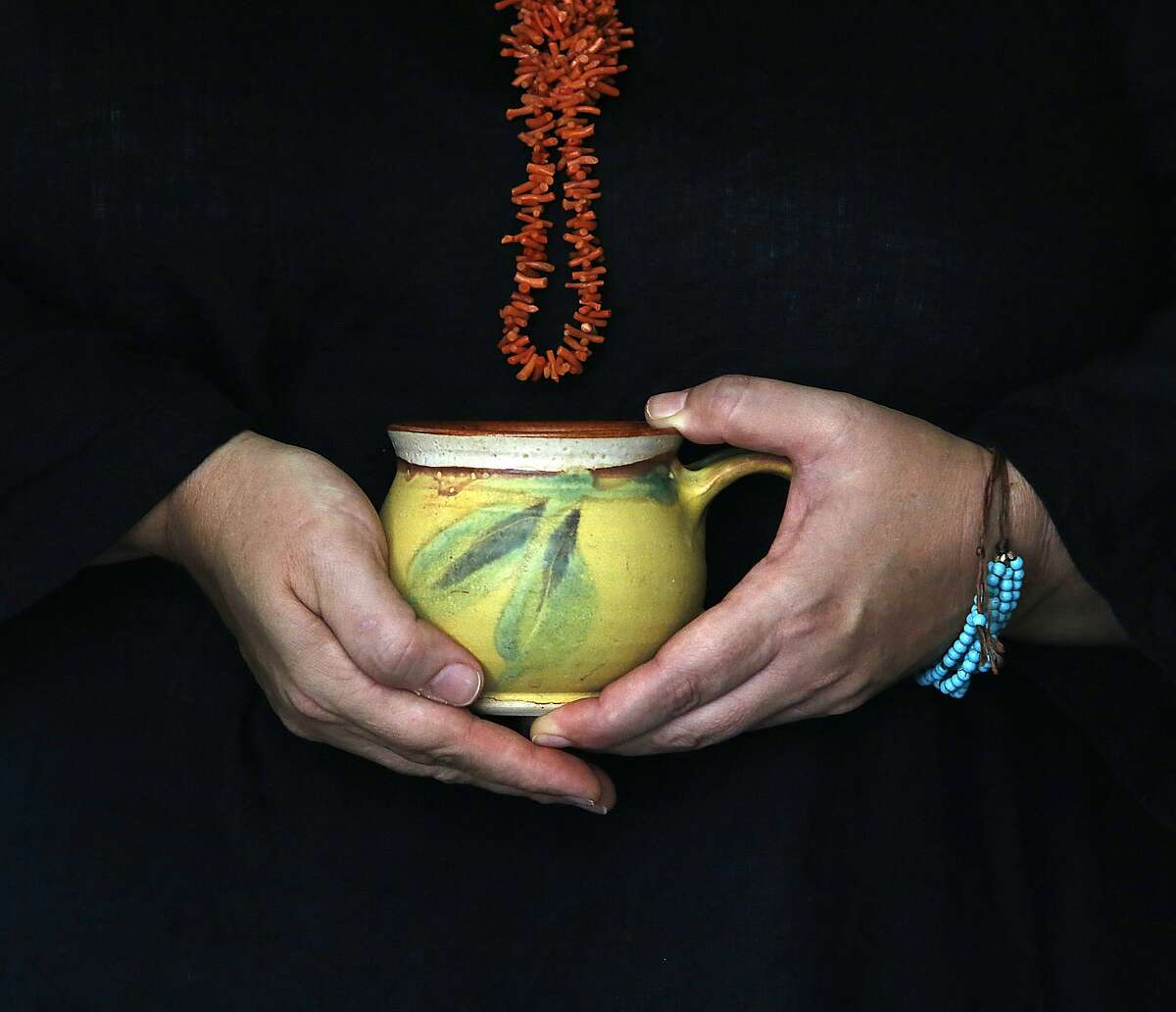 Writer Dana Velden has a new book a "Finding Yourself in the Kitchen" about her Zen practice and her life in the kitchen in Oakland, Calif., on Monday, September 21, 2015. In her book she mentions meditating with a cup of tea and is having PG Tips tea. The coral necklace is her grandmother's.