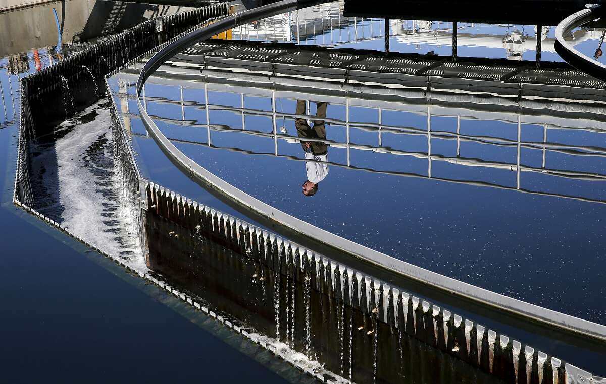 Plant operations manager Dan Gallagher is seen reflected in a secondary clarifier as recycled water travels through the cleaning process, during a tour of the Dublin San Ramon Regional Wastewater Treatment Facility in Pleasanton, Calif. on Tues. September 22, 2015.