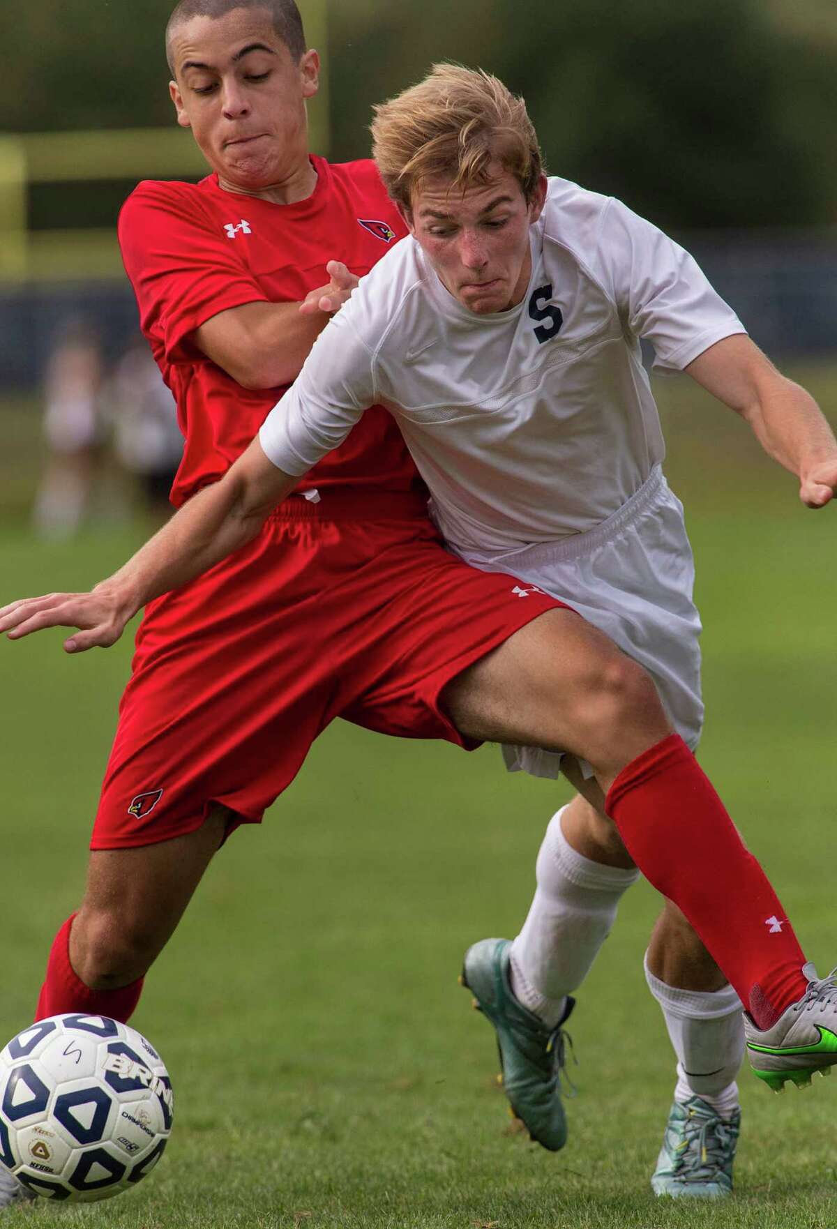 Greenwich’s Luis Carrillo and Staples’ Spencer Daniels battle for the ball during a boys soccer game played at Staples High School, Westport, CT on Tuesday, September 22, 2015.