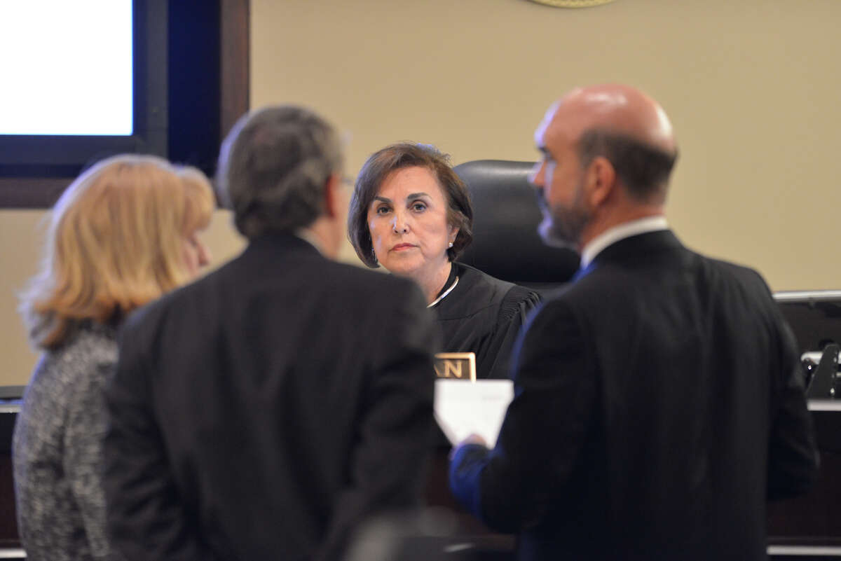 State District Judge Mary Roman listens to prosecuting attorney's Julie Wright (left), Bill Pennington (2nd from right) and defense attorney Paul Goeke (right) during the first day of the the capital murder trial of Mark Anthony Gonzales. Gonzales is accused of killing Bexar County Sheriff's Sgt. Kenneth Vann in 2011.