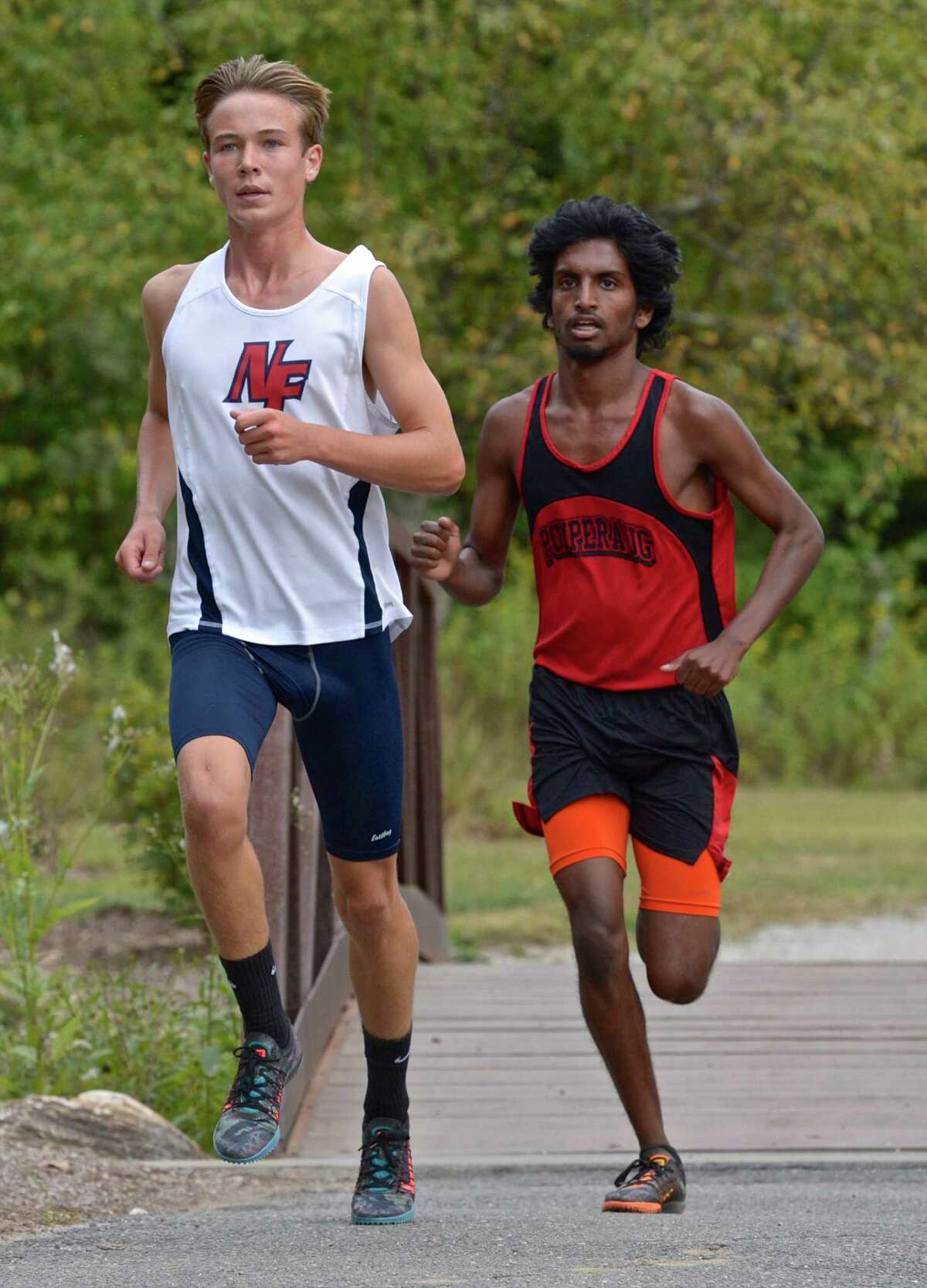 New Fairfield's Michael Rautter, left, won and Pomperaug's Alexander Abraham finished second in the boys high school cross country meet between New Fairfield, Pomperaug, New Milford and Masuk high schools on Tuesday afternoon, September 22, 2015, at Great Hollow Lake at Wolfe park, in Monroe, Conn.
