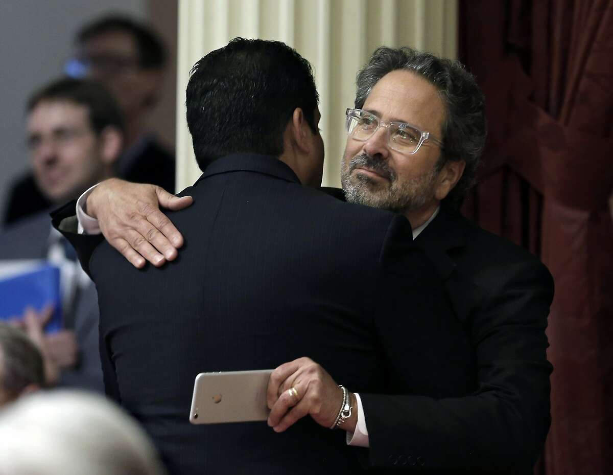 Assemblyman Richard Bloom, D-Santa Monica, right, is congratulated by Sen. Ben Hueso, D-San Diego, after his measure to phase out the use of microscopic beads in personal care products in California was approved by the Senate, Friday, Sept. 4, 2015, in Sacramento, Calif. (AP Photo/Rich Pedroncelli)