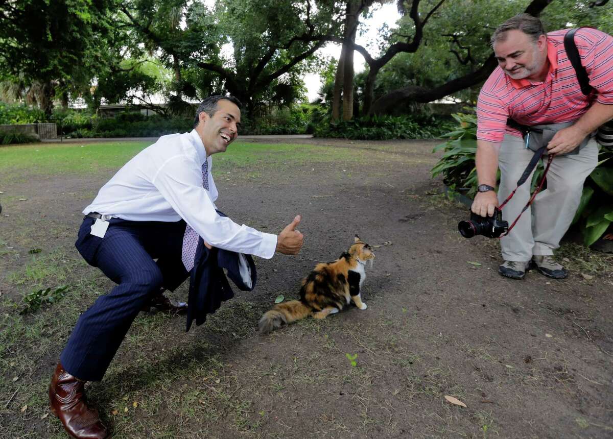 Texas Land Commissioner George P. Bush, left, poses with Bella the official Alamo cat following a news conference earlier this month to celebrate the $31.5 million the General Land Office received to preserve and develop the Alamo. A reader defends Bush for restructuring his office.