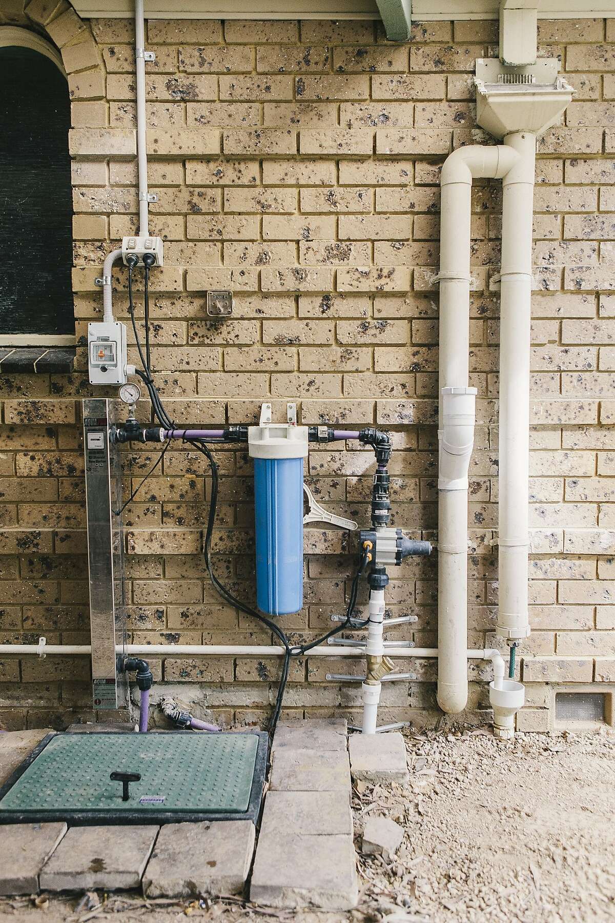 John Harvey, 75, a retired Melbourne homeowner, installed an impressive array of recycling and gray-water systems that have cut his water bill to zero.