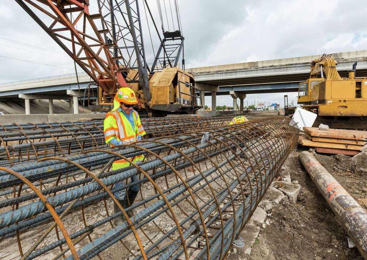 Gerson R. Chavez works stringing steel for a highway support column beside the northbound lane of Interstate 45 just south of El Dorado on May 5, 2015.