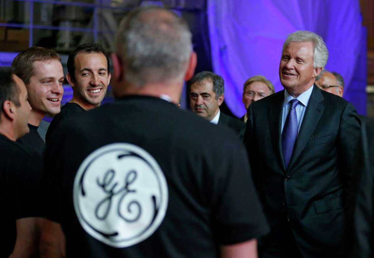 In this file photo, General Electric Chairman and CEO Jeffrey Immelt (R) chats with employees during a visit at the gas turbines production unit of the GE plant in Belfort, France. Immelt is striking deals with foreign governments to move jobs out of the U.S. in exchange for export financing after Congress voted to discontinue funding for the U.S. Export-Import Bank.