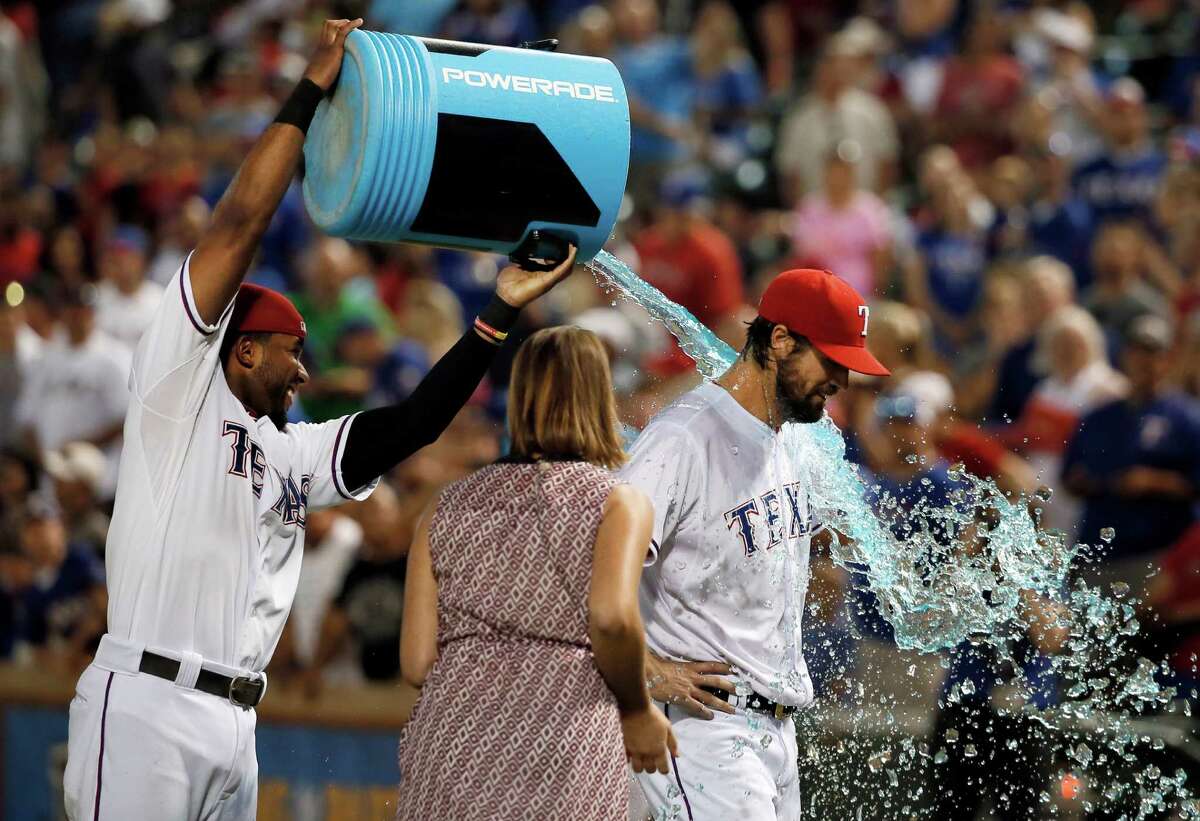 The Rangers' Elvis Andrus, left, dunks pitcher Cole Hamels, who was a splashy trade deadline acquisition for a team not yet in contention in the AL West at the time.