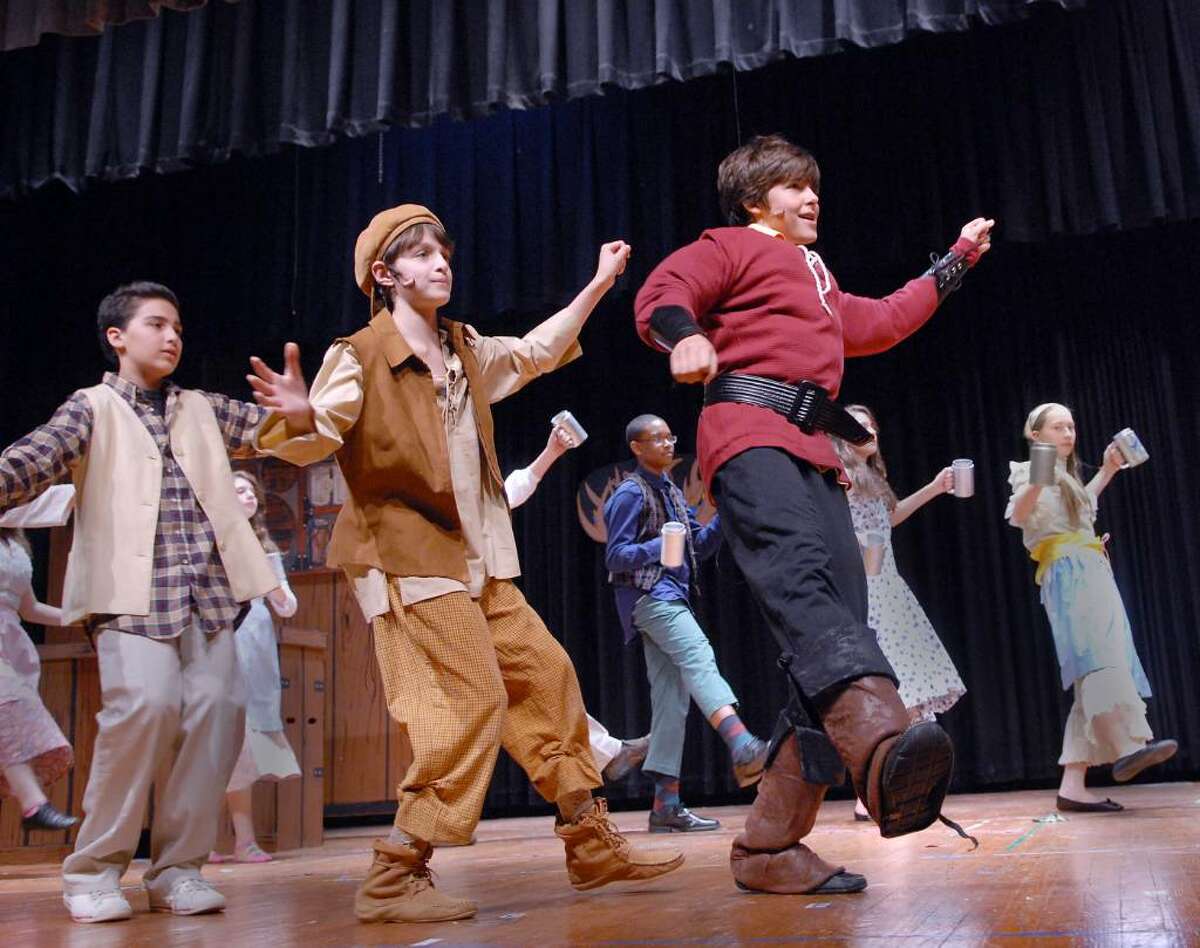 Central Middle School 8th grader, Henry Ricciardi, right, leads the singing and dancing as Gaston during a dress rehearsal of Beauty and the Beast, Jr., Wednesday afternoon, March 24th, 2010.