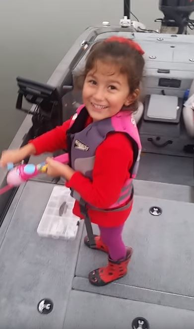 This little girl just owned a 20-inch bass with a Barbie fishing pole